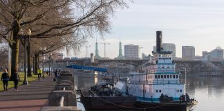 The twin towers of the Oregon Convention Center, site of the 2018 ADI Conference, break the Portland skyline behind the Sternwheeler Portland, which houses the Oregon Maritime Museum and is berthed along the Tom McCall Waterfront Park on the Willamette River.