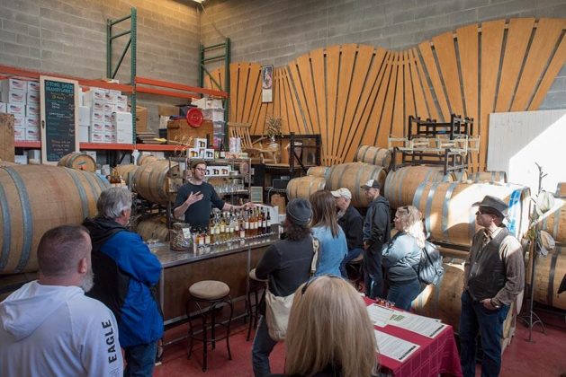 A distillery bus tour winds through the tasting room and enjoys samples at Stone Barn Brandyworks.