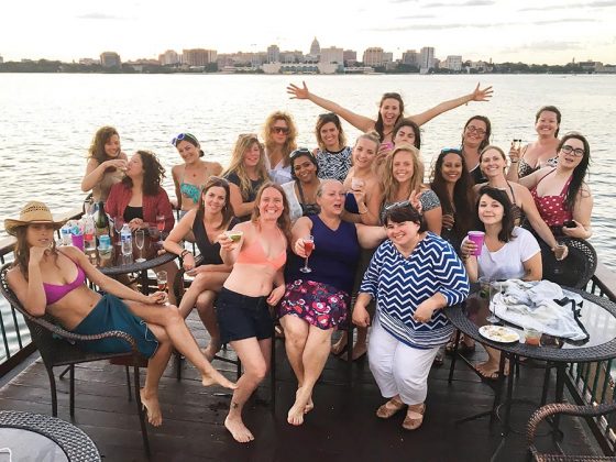 Liz Henry, center in purple, enjoys the Pontoon Porchboat Outing with the Spirited Women, a group formed from the bartending community in Madison, WI. These gatherings have raised money for charitable causes, including the local Rape Crisis Center and Safer Bar Training.